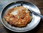 Bara, a Newari lentil pancake on a metal plate, from a cafe in Kathmandu.