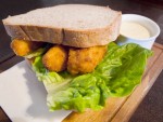 A fish finger sandwich with lettuce and tartar sauce from a  pub in London, England